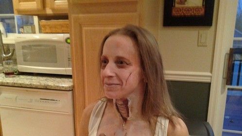 a somewhat hand build and two dimensional makeup. time budget was one hour, this for Halloween.
The neck opening was simply handbuilt with cotton and latex, the Trachea is all 2D makeup with a coating of Prosaide to give it gloss
